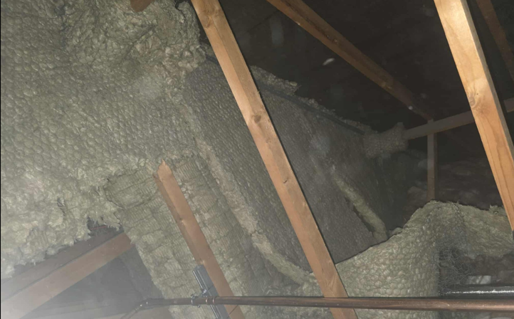 Existing barrier material and services in the roof space before replacement works